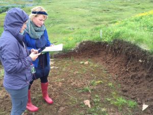 Rannveig shows Erin a recent dig, believed to be the wall of a house.